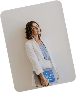 Emma Maidment holding her book Find Your Flow